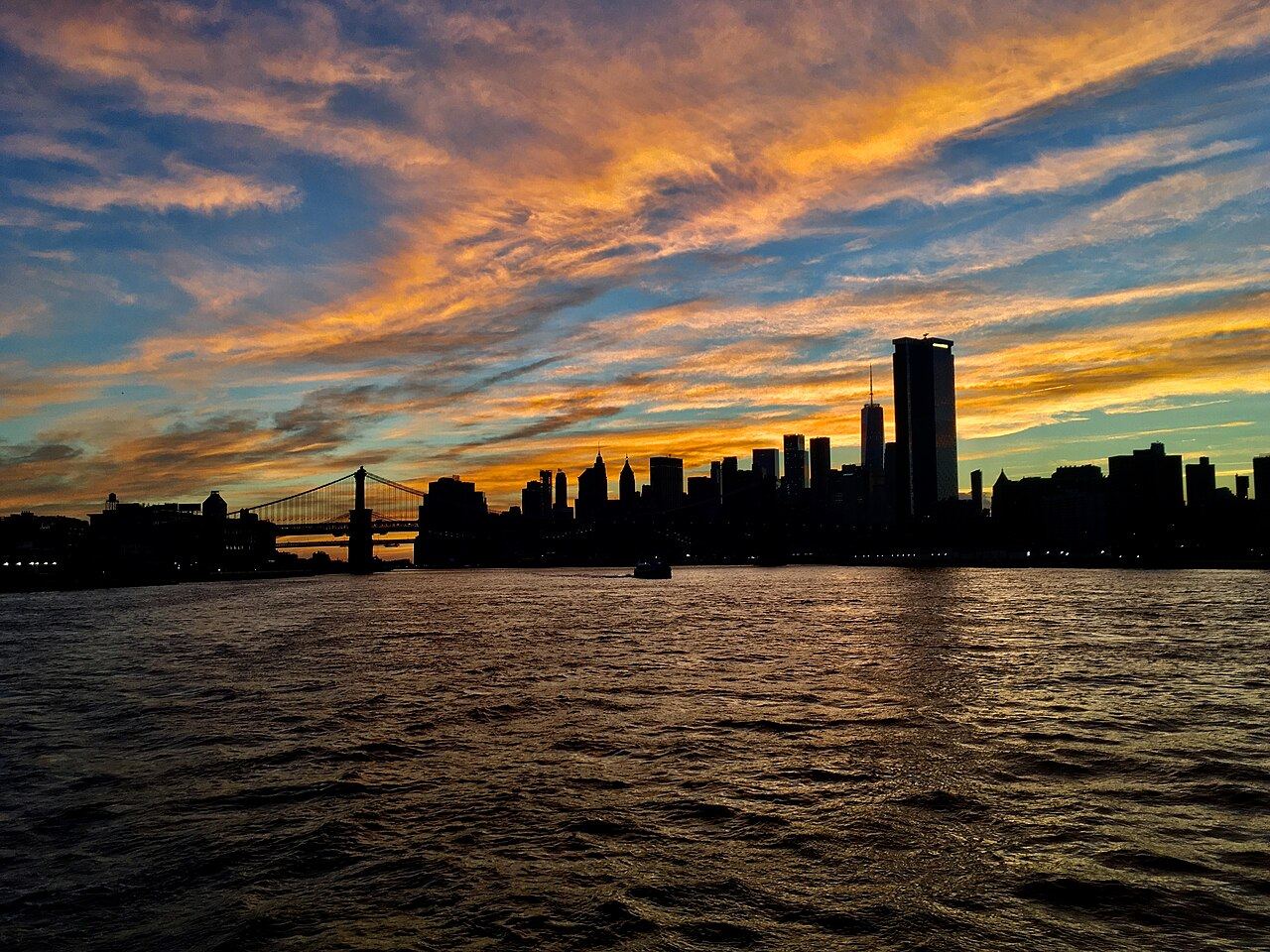 Lower Manhattan skyline at sunset from New York Harbor